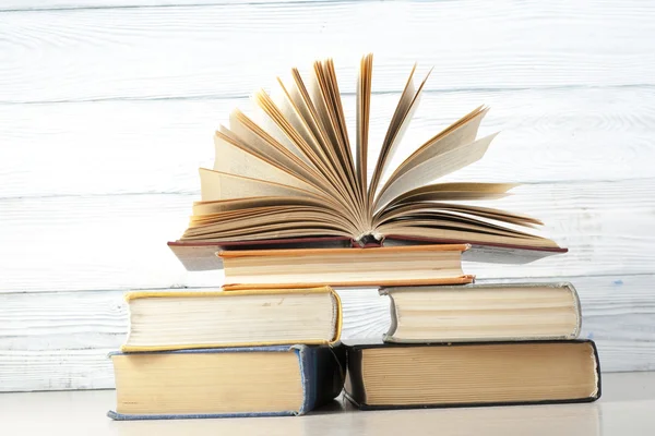 Open book, hardback books on wooden table. Education background. Back to school. Copy space for text. Stock Photo