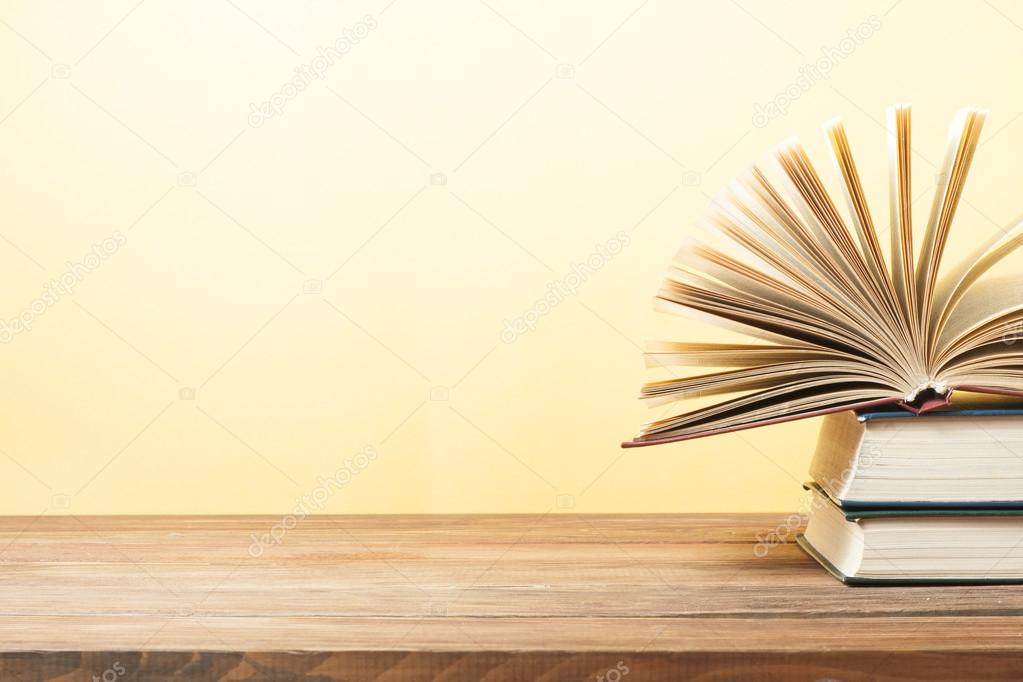 https://st2.depositphotos.com/8187094/11954/i/950/depositphotos_119544278-stock-photo-open-book-hardback-books-on.jpg