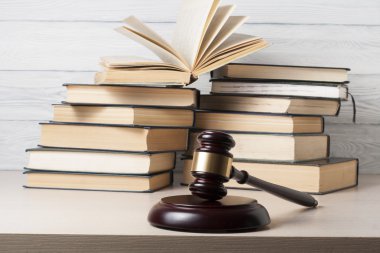 Law concept - Book with wooden judges gavel on table in a courtroom or enforcement office. clipart