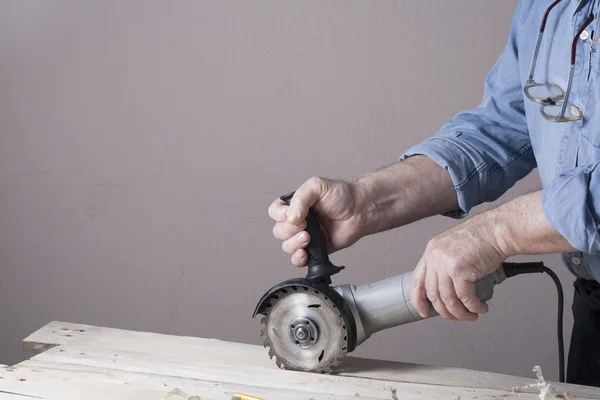 Carpenter working with plane on wooden background at Building Site. Joiner workplace — Stock Photo, Image