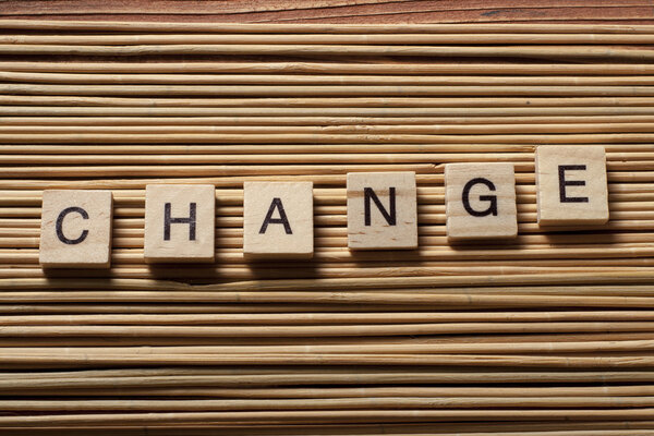 text of CHANGE on wood abc cubes at wooden background.