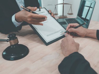 Professional lawyer advising client on commercial contract in law office. Concept of judicial process, law, lawyer and judge in court with gavel banging on table.