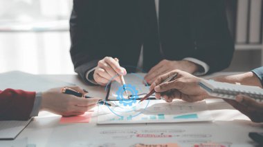 Business people discussing charts and graphs showing results of teamwork in a meeting to analyze financial reports, planning strategies, success.