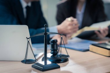 Avukat, yasal danışma toplantısında müvekkilini temsil eden ve yasal belgelere yardımcı olan yasal bir belgeye imza noktalarını işaret ediyor..