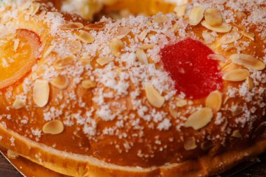 Geleneksel Roscon de Reyes hamur işi. Bu mevsimlik tatlı, Üç Krallar Günü kutlamaları için şekerli meyvelerle süslenmiştir..