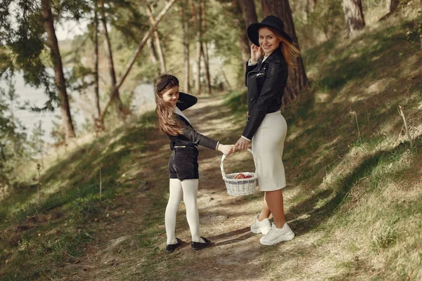 Elegant mother with daughter in a summer forest — Stock Photo, Image