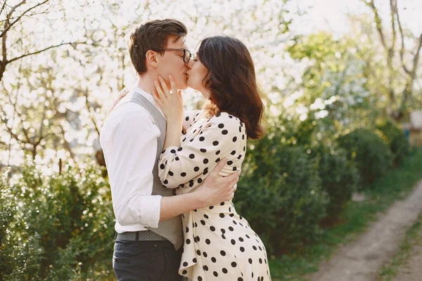 Young man and woman couple in a blooming garden — Stock Photo, Image