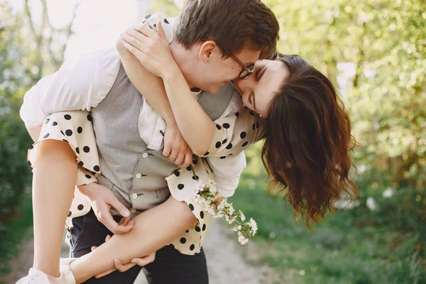 Junger Mann und Frau in einem blühenden Garten — Stockfoto