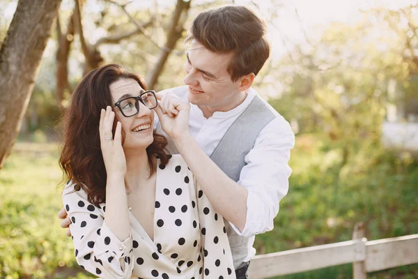 Young man and woman couple in a blooming garden — Stock Photo, Image