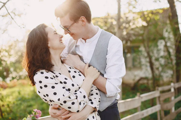 Young man and woman couple in a blooming garden — Stock Photo, Image