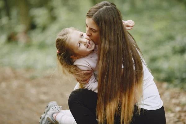 Mother and daughter in a summer forest — Stock Photo, Image