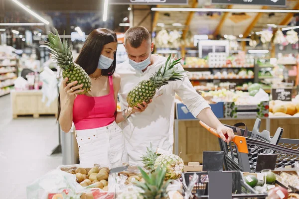 Couple in a medical masks in a supermarket