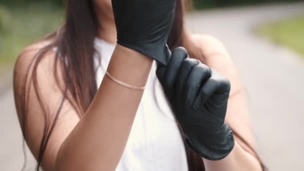 Nahaufnahme weiblicher Hände, die weiße antibakterielle Handschuhe anziehen — Stockvideo