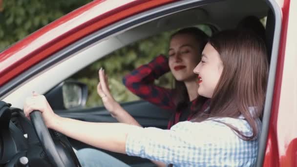 Amigas relajándose en el coche rojo en la naturaleza — Vídeos de Stock