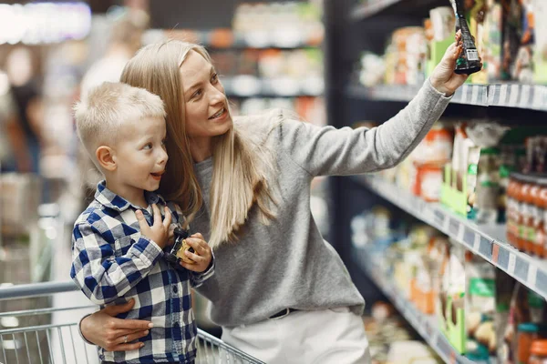 Woman at the supermarket with her son