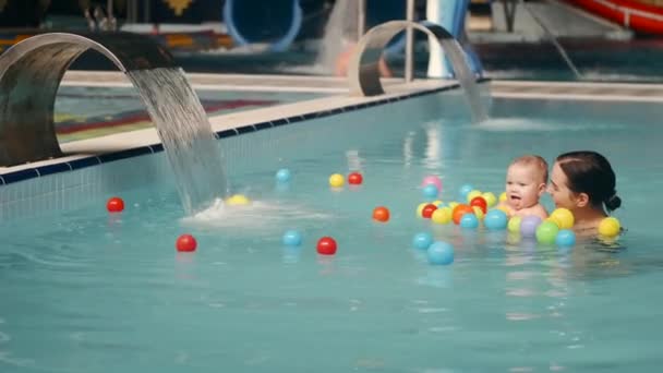 Baby spielt bei Babyschwimmstunde mit Spielzeug — Stockvideo