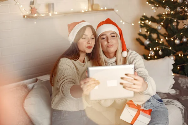 Women having fun with her friends video chat at home for Christmas