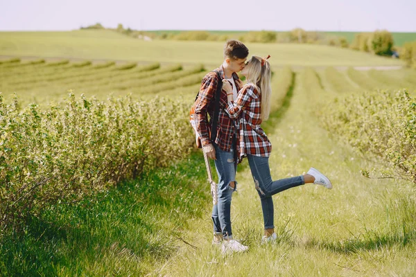 Ung man och kvinna par i ett sommarfält — Stockfoto