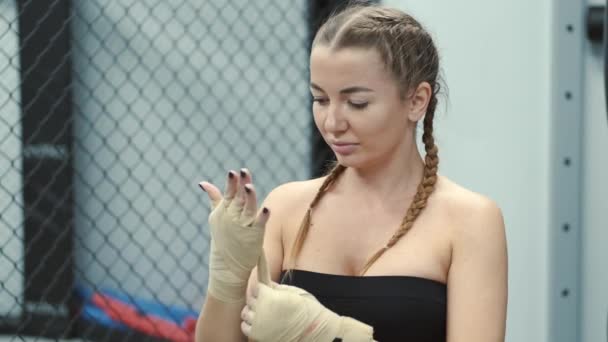Bileklerini saran kadın spor salonunda boks yapmaya hazırlanıyor. — Stok video