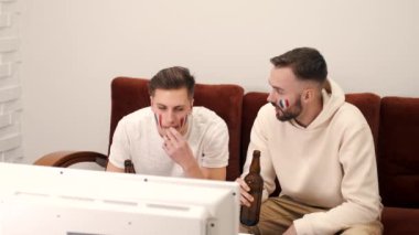 Bir grup mutlu arkadaş televizyonda bira eşliğinde maç izliyorlar.