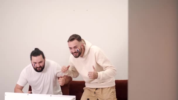 Group of happy friends fans watching a match on tv with beer — Stock Video