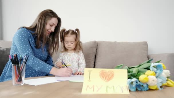 Menina com mãe grávida desenhando um quadro em casa — Vídeo de Stock