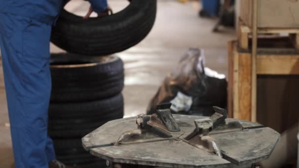 Servisní muž nasadil pneumatiku na kolo auta speciálním nástrojem — Stock video