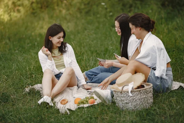 Group of girls play cards in a park — Stock Photo, Image