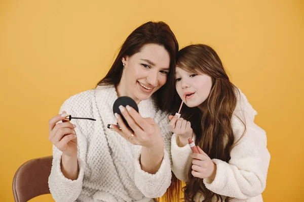 Mom and daughter doing makeup cosmetics
