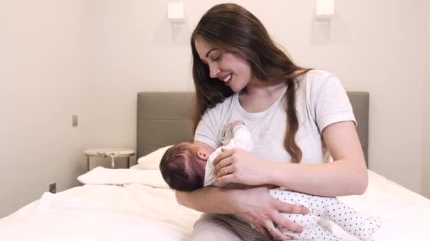 Mother breast feeding little baby in bedroom — Stock Video