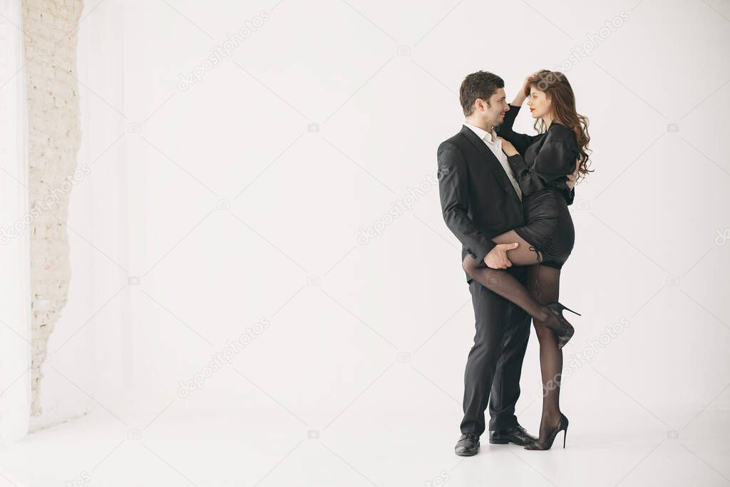 Portrait of young couple in love posing at studio