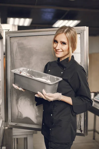 Female chef cooking at ice cream factory