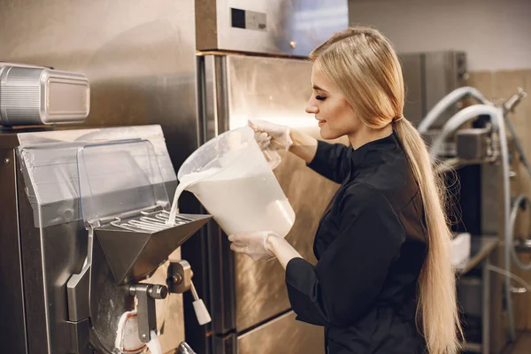 Chef pouring milk into the machine in the restaurant kitchen