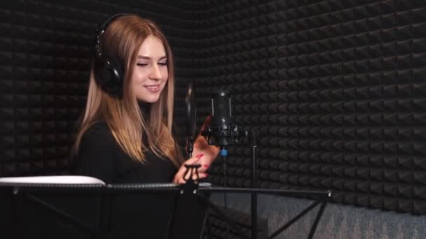 Vrouwelijke zangeres die een lied opneemt in de muziekstudio — Stockvideo
