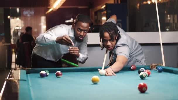 Shot of a young black male in a billiards playroom — Video