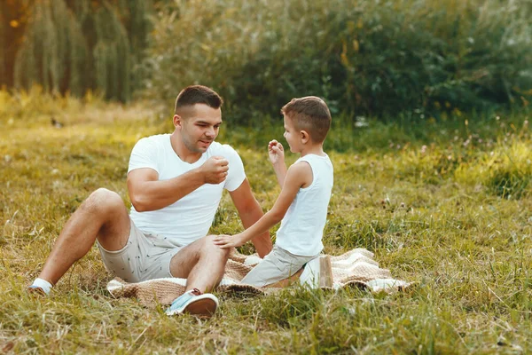 Söt familj som leker på ett sommarfält — Stockfoto