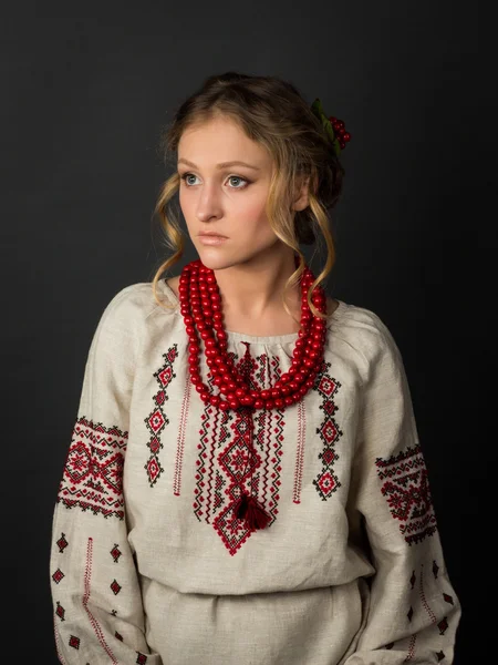 Beautiful serious young woman in Ukrainian embroidery — Stock Photo, Image