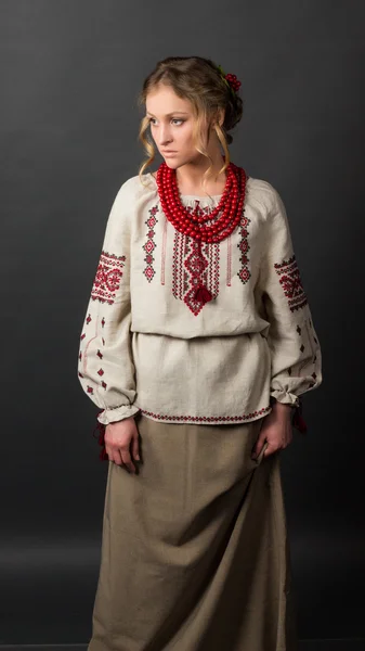 Beautiful serious young woman in Ukrainian embroidery — Stock Photo, Image