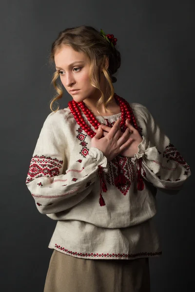 Beautiful serious young woman in Ukrainian embroidery — Stock Photo, Image