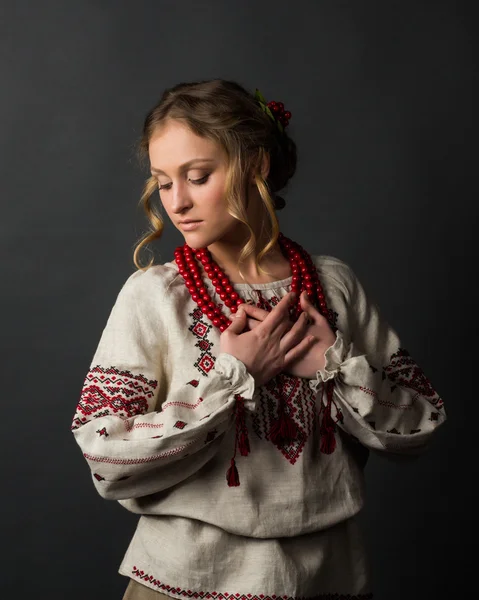 Beautiful serious young woman in Ukrainian embroidery — Stock Photo, Image