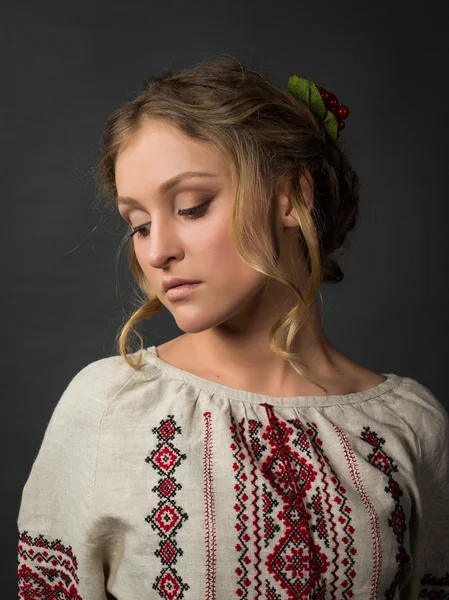 Beautiful serious young woman in Ukrainian embroidery — Stock Photo, Image