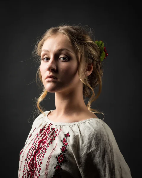 Beautiful serious young woman in Ukrainian embroidery — Stock Photo, Image