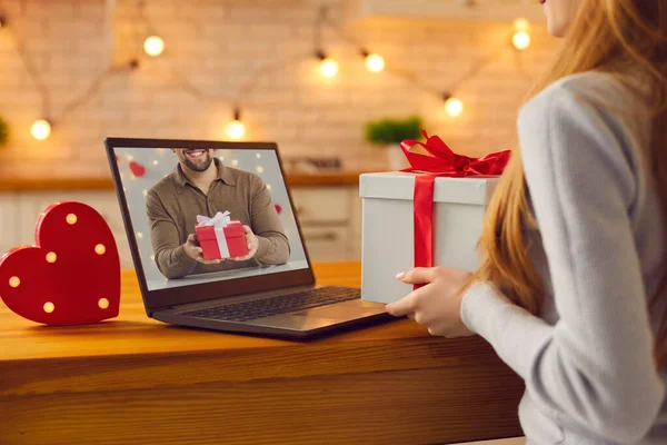 Couple in love video calling each other during lockdown and showing presents they prepared