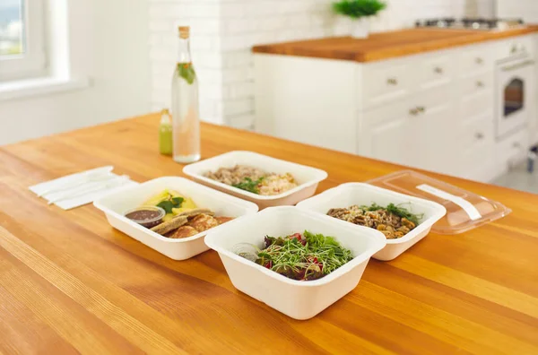 On the table four containers with ready a variety of healthy food ordered in the delivery service. — Stock Image On the table four containers with ready a variety of healthy food ordered in the delivery service. Stock Image