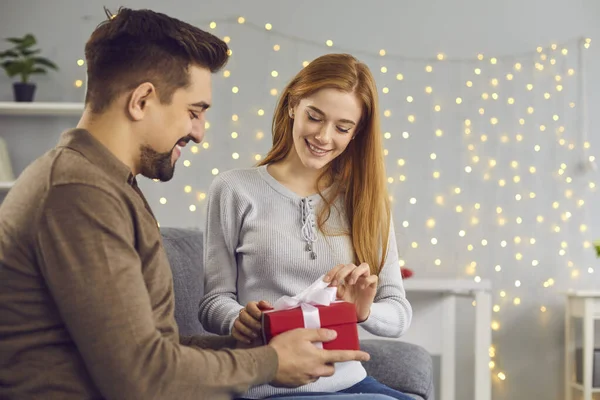 Smiling young woman opening box with birthday or Valentine present from her boyfriend — Foto de Stock