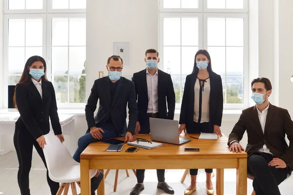 Group of business colleagues team in medical protective masks during meeting — Stock Photo, Image