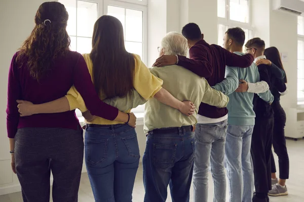 Group of diverse community members embracing each other, feeling strong and united