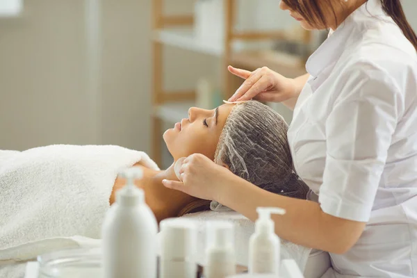 Női kozmetológus tisztító nők arcát pamut párna után vagy előtt bőrápolási eljárás — Stock Fotó