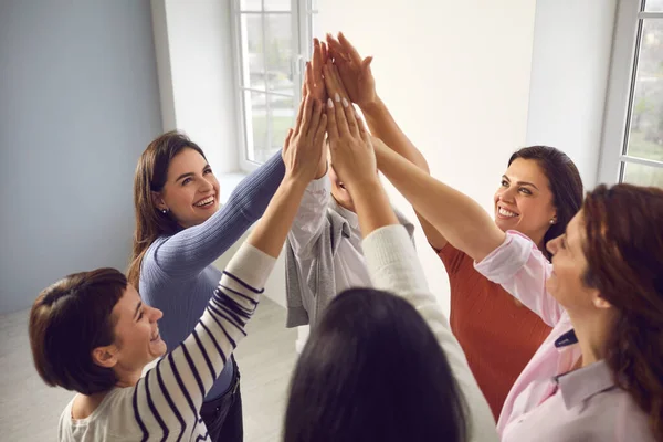 Team of happy young women joining hands, feeling united, confident and empowered — Stock Photo, Image
