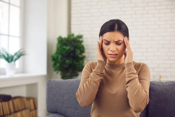 Tired stressed young woman touching her temples, suffering from headache or migraine — Stock Photo, Image